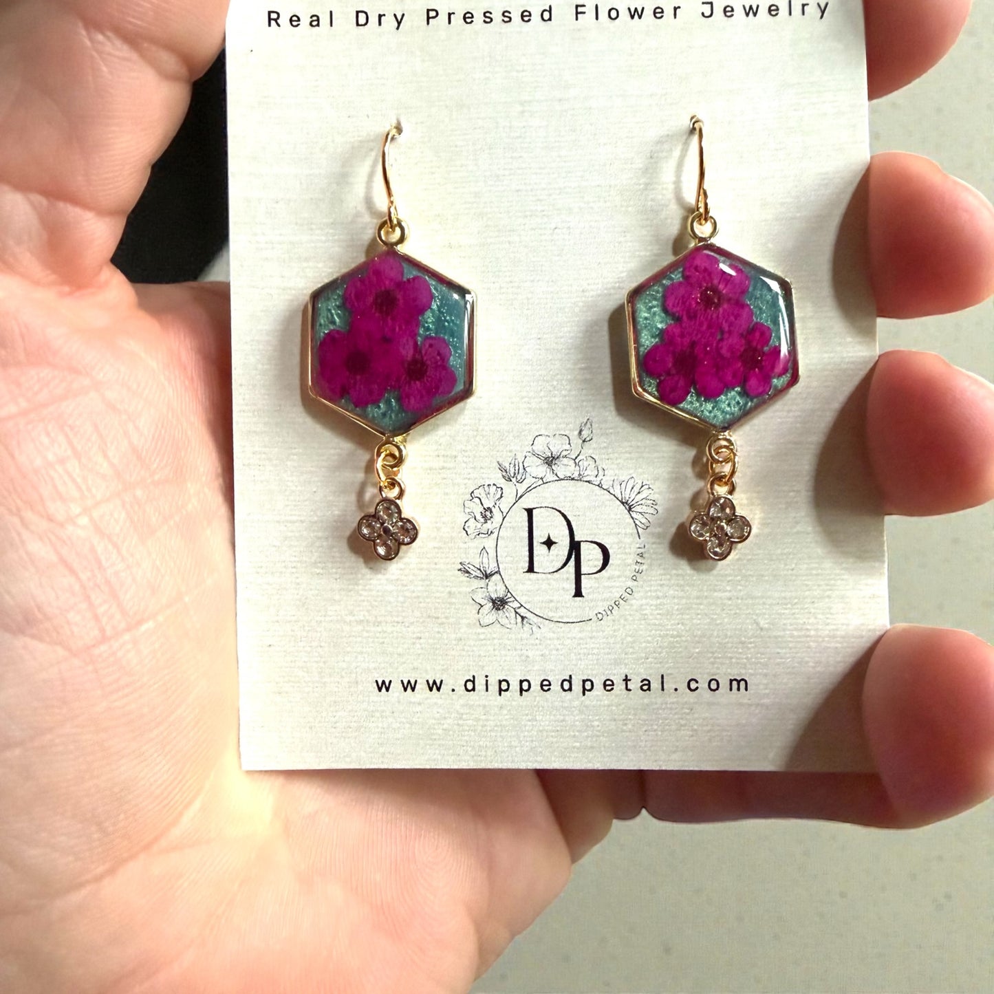 Teal Colored Mica Powder Background with Hot Pink Plum Blossoms
