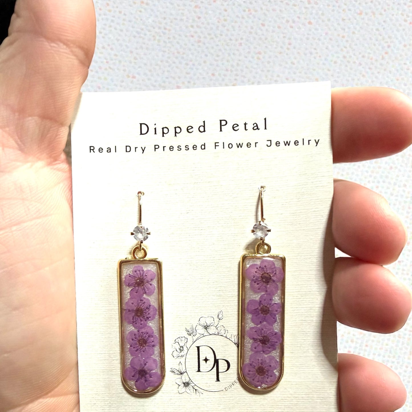 Opal Colored Mica Powder Background with Purple Plum Blossoms