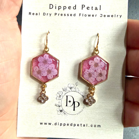 Pink Colored Mica Powder Background with Light Purple Plum Blossoms