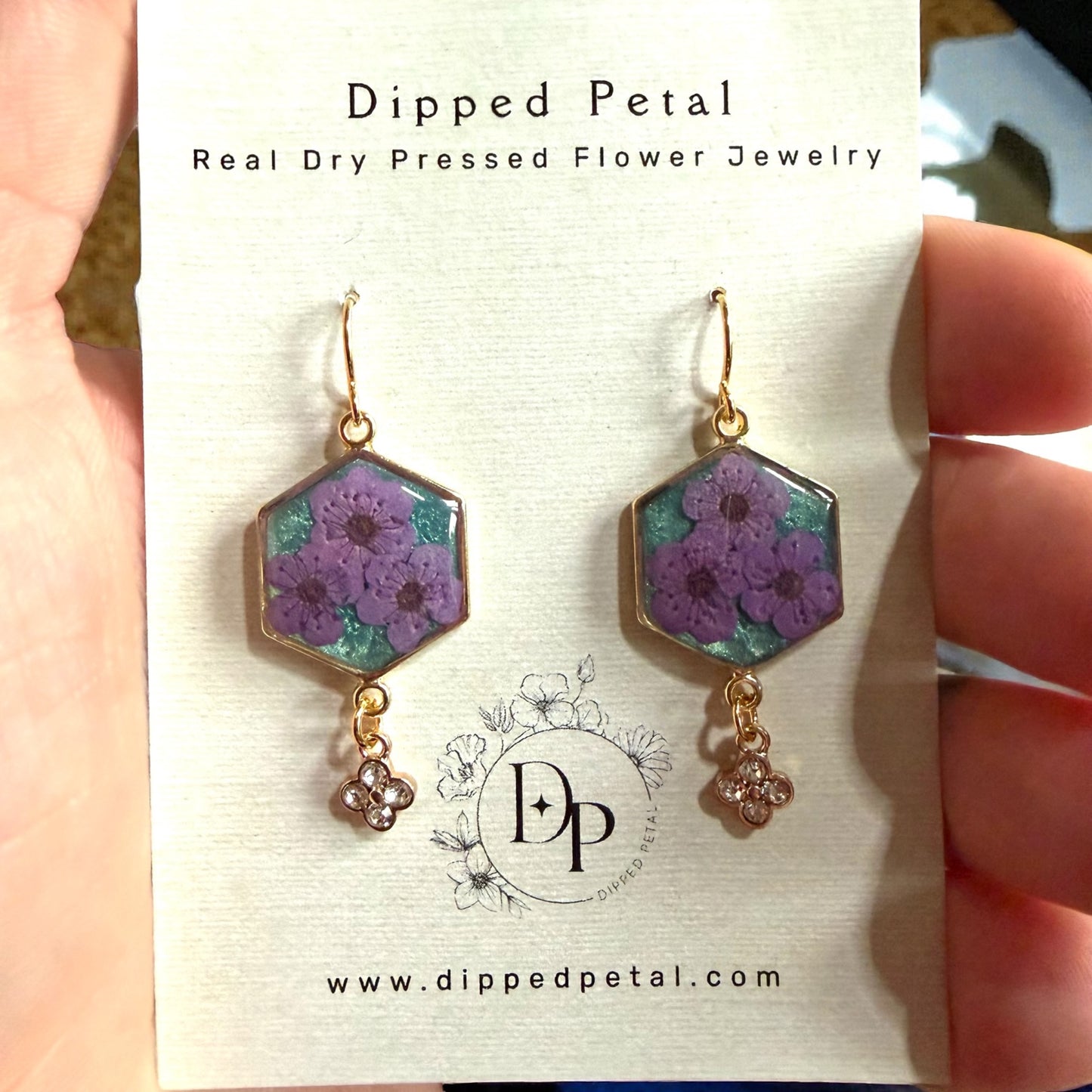 Teal Colored Mica Powder Background with Purple Plum Blossoms