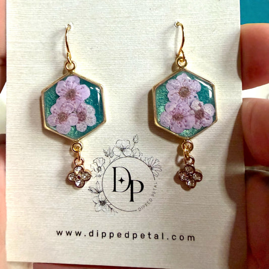 Teal Colored Mica Powder Background with Light Purple Plum Blossoms