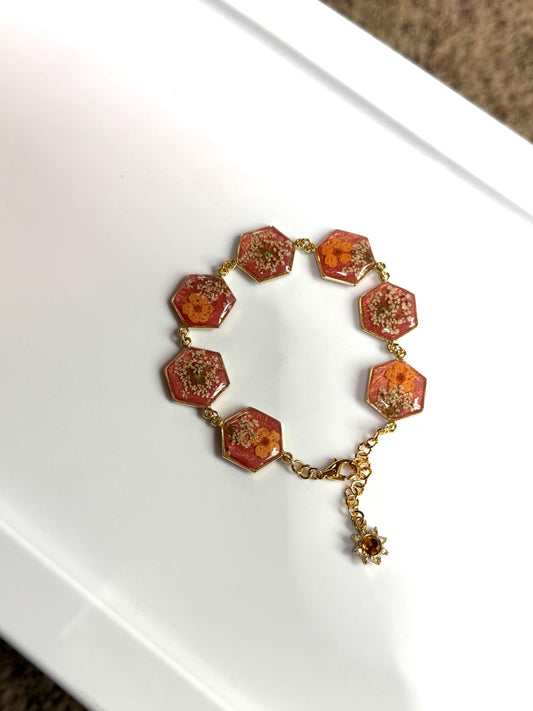 Gold Colored Bracelet with Coral Colored Mica Powder, Orange Plum Blossoms and Queen Anne’s Lace