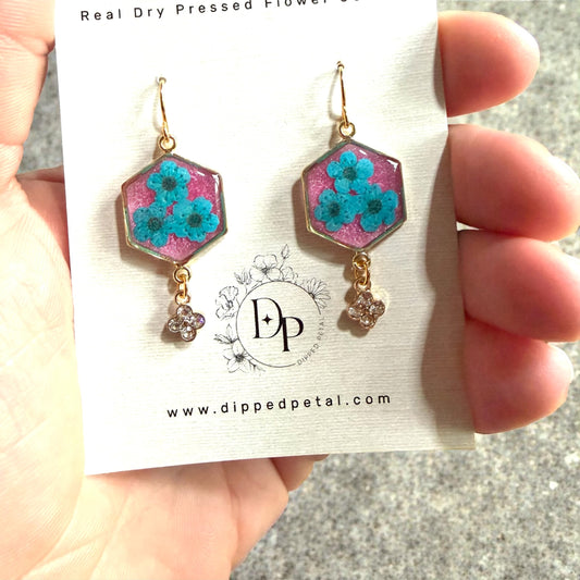 Pink Colored Mica Powder Background with Teal Plum Blossoms