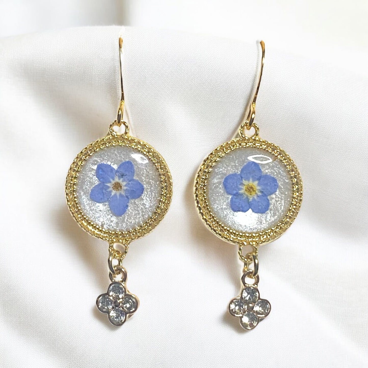 Opal/White Colored Mica Powder with Blue Forget-Me-Nots and a Rhinestone Charm