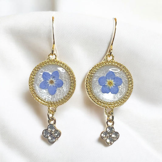 Opal/White Colored Mica Powder with Blue Forget-Me-Nots and a Rhinestone Charm