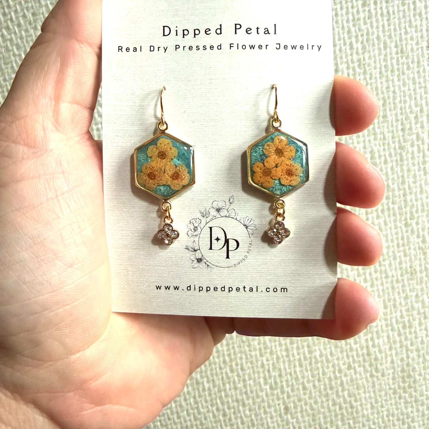 Teal Colored Mica Powder Background with Orange Plum Blossoms
