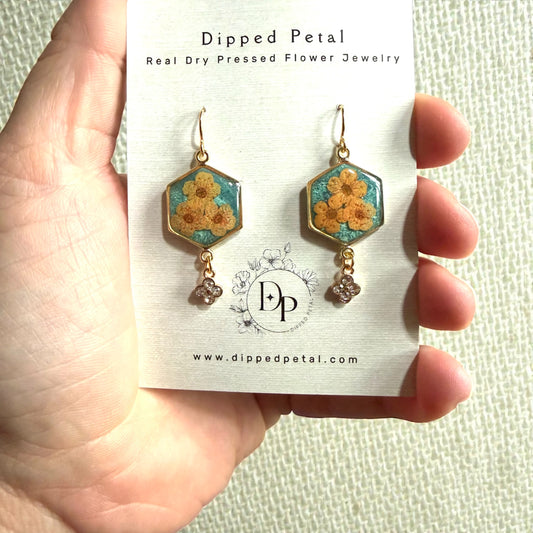 Teal Colored Mica Powder Background with Orange Plum Blossoms