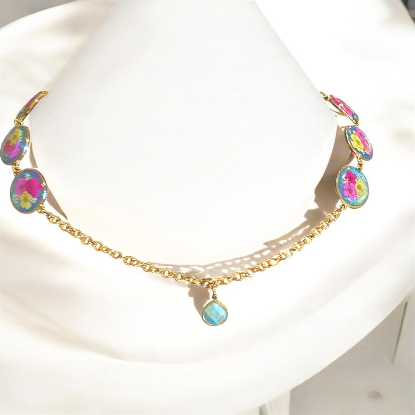 Teal colored Mica Powder with Yellow, and Pink Plum Blossoms with pieces of Queen Anne’s Lace