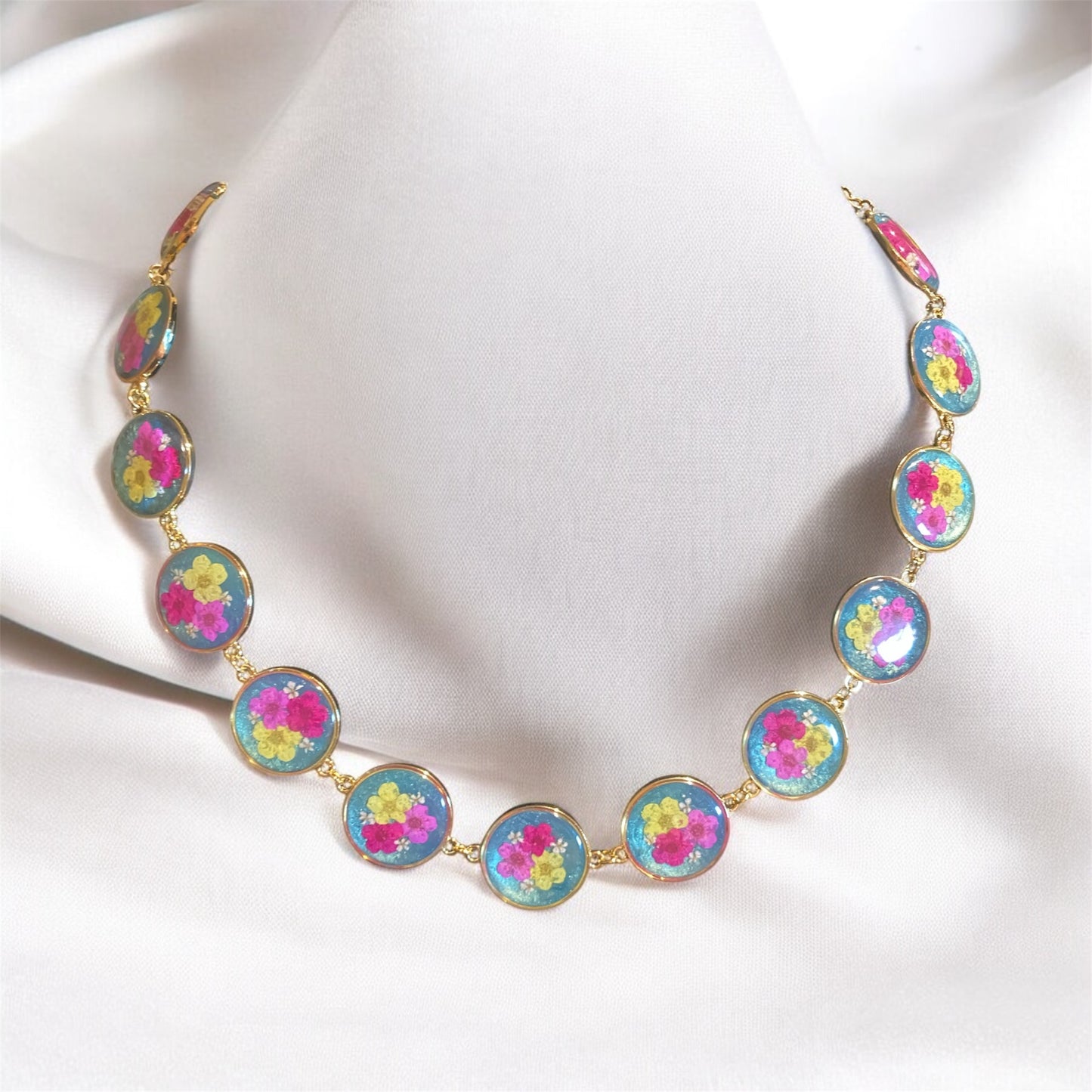 Teal colored Mica Powder with Yellow, and Pink Plum Blossoms with pieces of Queen Anne’s Lace