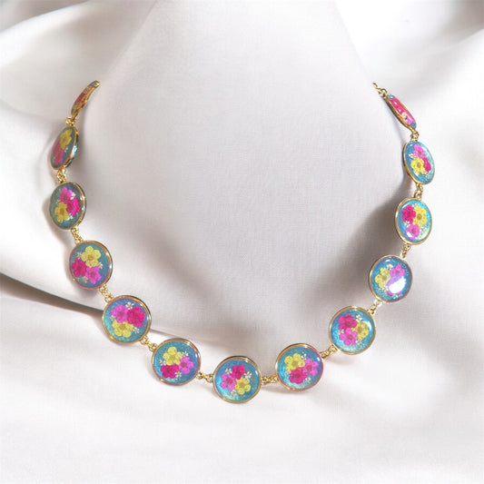 Teal colored Mica Powder with Yellow, and Pink Plum Blossoms with pieces of Queen Anne’s Lace