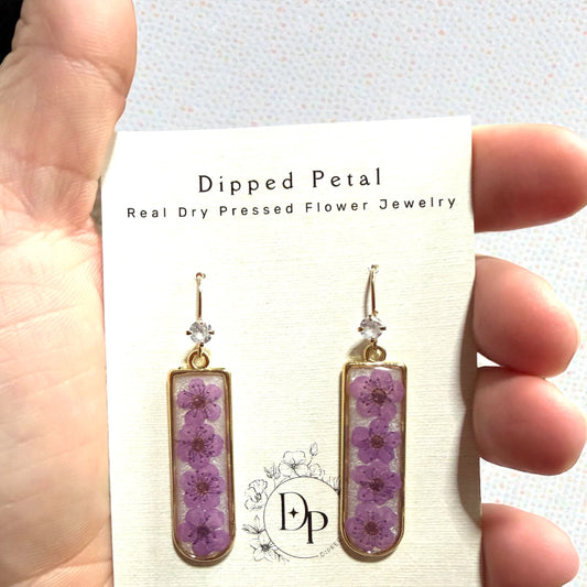 Opal Colored Mica Powder Background with Purple Plum Blossoms